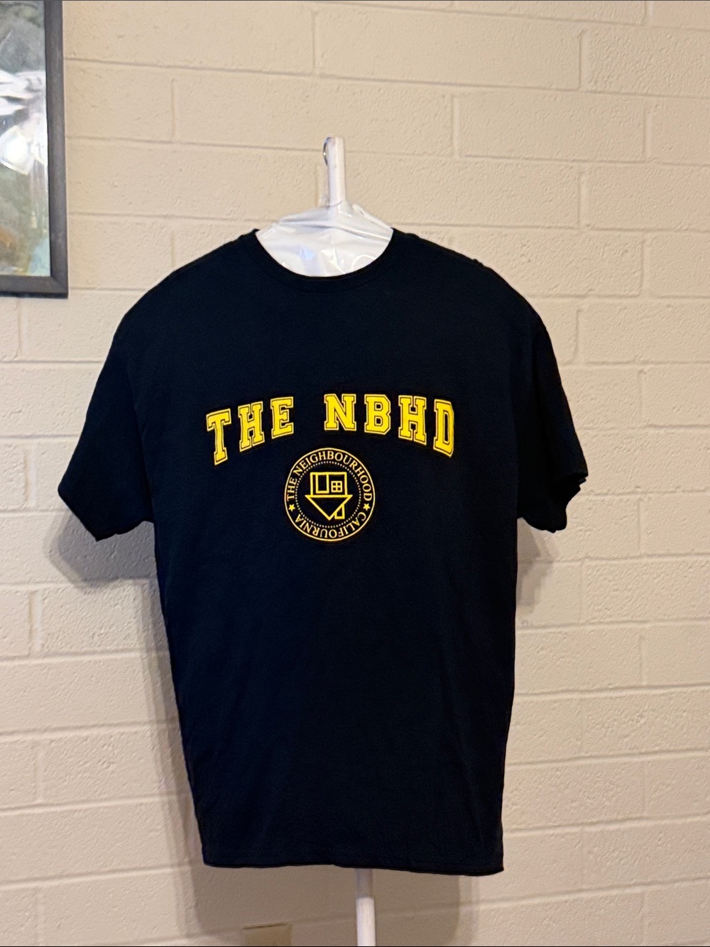 The NBHD Short Sleeve Logo Tee in Black with Yellow Print